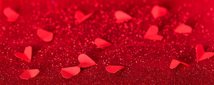 s day. Many red hearts on a background of shining crystals