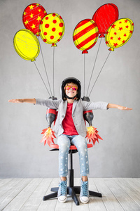 快乐的孩子玩玩具喷气背包。 儿童飞行员准备飞行。 成功创新与领导者理念
