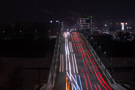 这辆汽车在夜间现代化城市的高速公路上轻驶