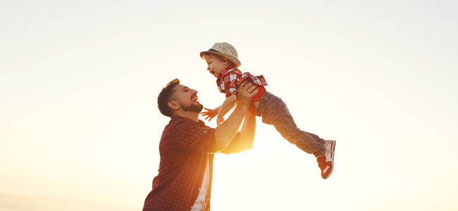 s day. Happy family father and toddler son playing and laughing 