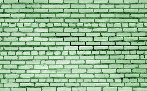 旧砖墙表面绿色色调。 抽象的建筑背景和设计纹理。