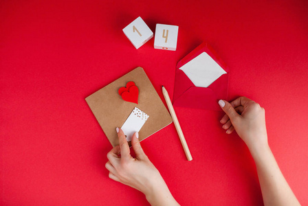 s day concept. Valentine, hearts, pencil, wooden cubes with numb