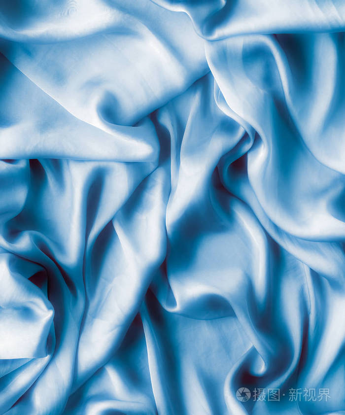 蓝色柔软的丝绸波,平坦的,优雅的织物纹理,抽象的背景和现代粉彩的