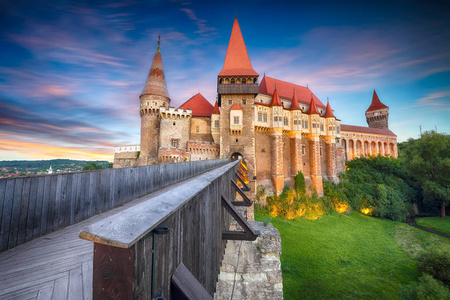 s Castle with wooden bridge. Fantastic summer sunset in Hunedoar