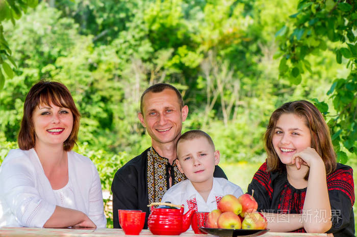 乌克兰人家庭在户外的一张桌子上,在大自然的背景下