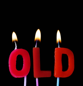 用红色生日蜡烛在黑色背景下拼出的旧词