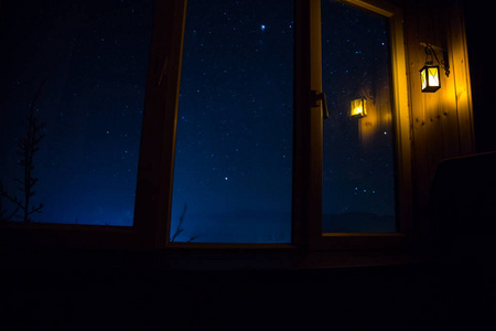 从黑暗的房间透过窗户看到星星的夜景.