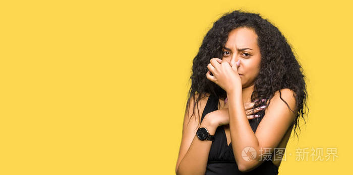 穿着时尚裙子,闻着一些臭味和令人恶心的难以忍受的气味,用手指在鼻子