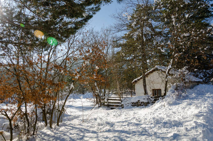 冬天的风景，山上有一间木屋。