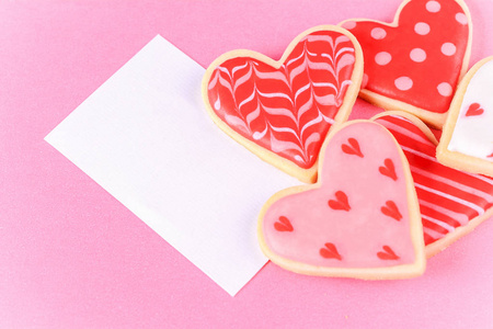 s day cookies with greeting card on pink background