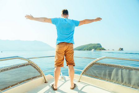 一个人站在船的鼻子边。暑假假期