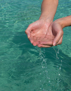 s hands. Turquoise water background