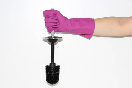 s hand. Latex gloved hand. A woman holds a toilet brush in her h