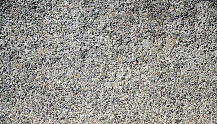 作为背景的石墙的旧城堡纹理的一部分. 带有混凝土连接的装饰随机尺寸