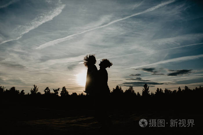 幸福的一对相爱的夫妇在日落时度过美好的时光