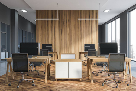 开放空间办公室内部有灰色墙壁木制地板一排排小木电脑桌和金属椅子。 3D渲染