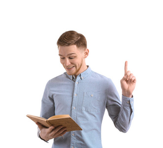 一个英俊的年轻人，带着书，在白色的背景上举起食指