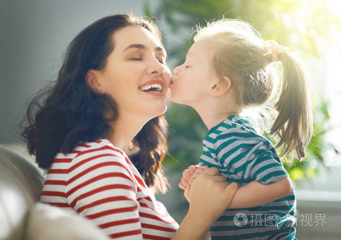 s day Mom and her daughter child girl are playing, smiling and 