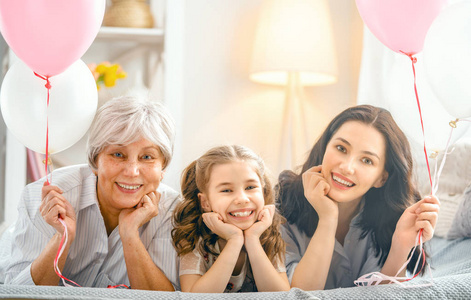 s day Child, mom and granny with air balloons. Grandma, mum and