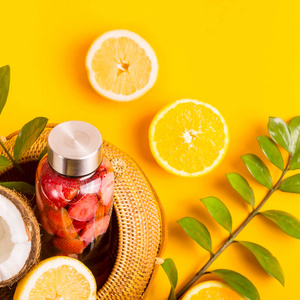 s summer straw bag on a yellow background among fruit