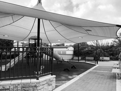 s playground are shadow under  a tent.