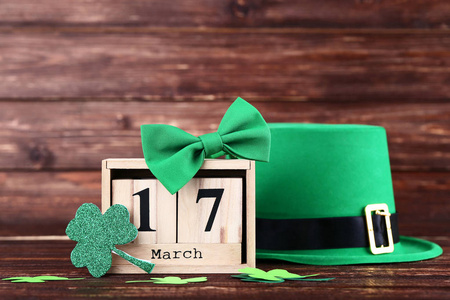 s Day. Green hat with clover leafs, wooden calendar and bow tie