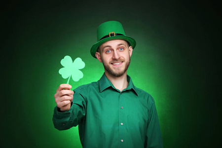 s Day. Young man wearing green hat with paper clover