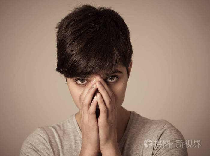 特写美丽的年轻女子的肖像,悲伤的眼睛看着悲惨和忧郁.