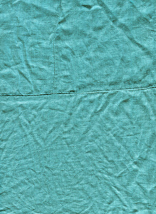 绿松石织物背景纹理。 来自纺织材料的绿松石背景