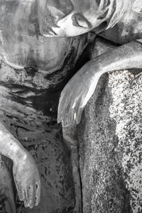 一个悲伤的女人靠在岩石上的雕像。理想的概念或事件。