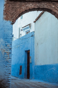 在城市厨师Chaouen Morocco的老街区，可以看到狭窄的街道和白色和蓝色的房子。