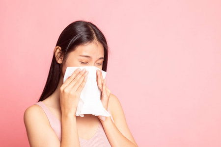 年轻的亚洲妇女生病并染上粉红色的流感