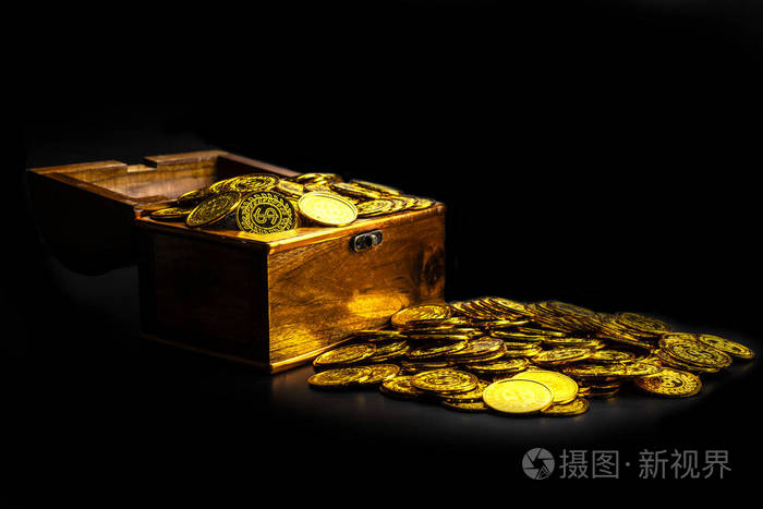 在黑色背景的宝箱上堆放金币