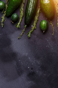 迷迭香孜然黄瓜牛油果黑色背景。 健康的食物概念。 厨房桌子上有美味的蔬菜和水果。 复制空间