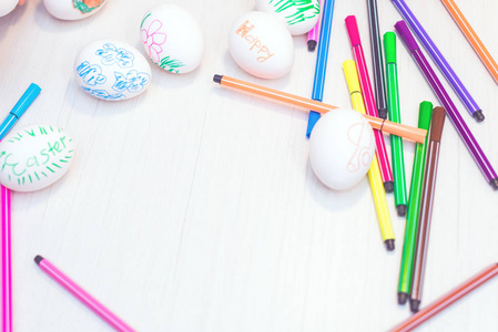 s drawings are on the table with markers. Easter ideas. Space fo