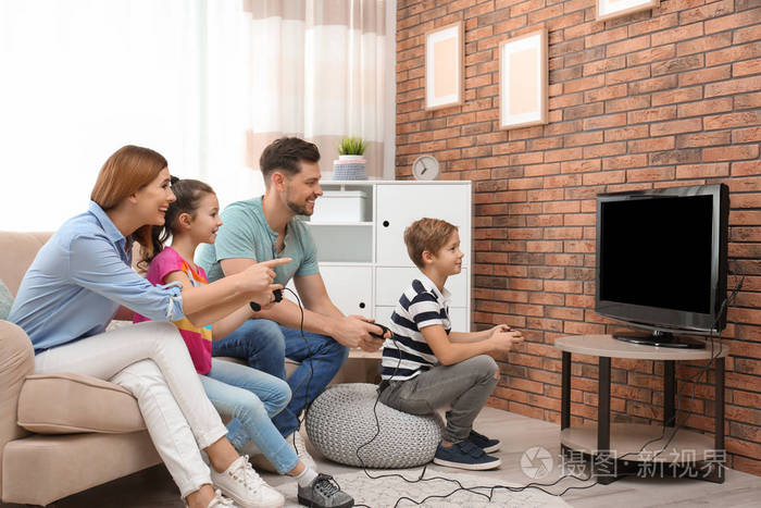 幸福的家庭在客厅玩电子游戏