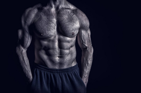 肌肉发达的身体训练在健身房的英俊健美男人