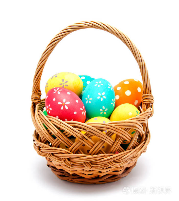 完美的彩色手工复活节彩蛋在篮子里隔离在白色上