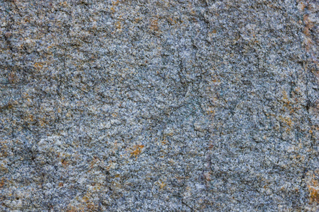 花岗岩纹理接近。 具有多孔表面的花岗岩岩石。 来自实心石头的背景。 天然材料图案