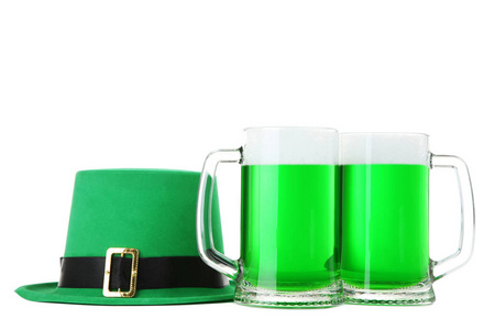 s Day. Glass mugs with green beer and hat isolated on white back