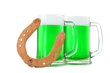 s Day. Glass mugs with green beer and golden horseshoe isolated 