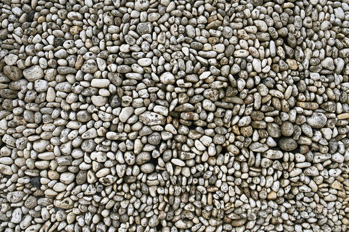 由自然纹理鹅卵石制成的墙体背景