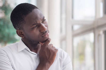  portrait of thoughtful black man thinking, planning, considerin