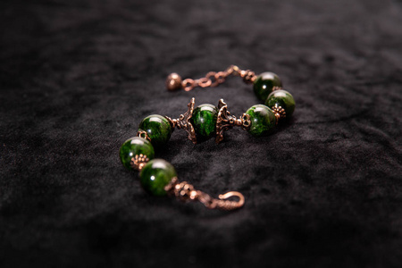 铁面上有绿色珠子和链子的手镯