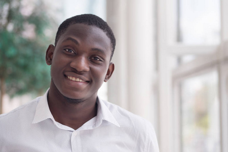  portrait of positive, friendly, happy, smiling African man in u