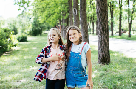 年轻女孩在绿色公园散步欢笑和玩耍，休息一下，积极的女学生女朋友