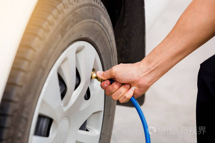 司机检查气压和轮胎中的充气,在旅行前保持安全