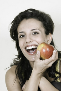 年轻的幸福微笑女人的红苹果