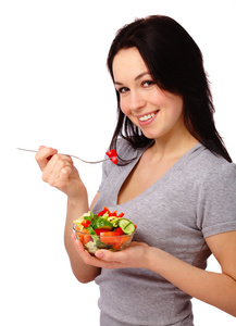年轻有魅力的女人吃蔬菜沙拉