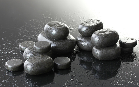 水疗中心的石头与灰色的背景上滴